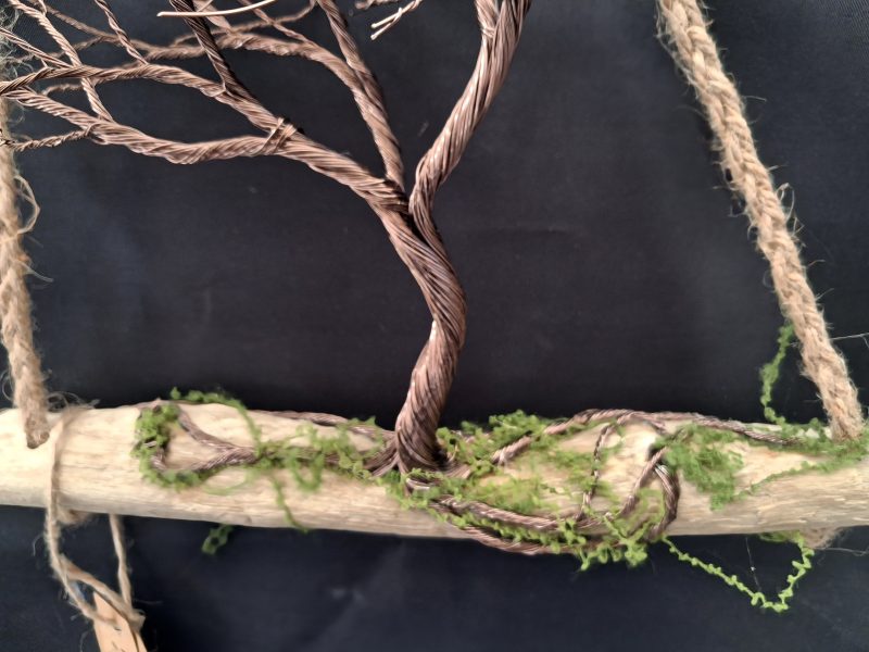 Windswept wire tree on natural driftwood
