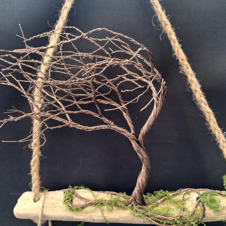 Windswept wire tree on natural driftwood