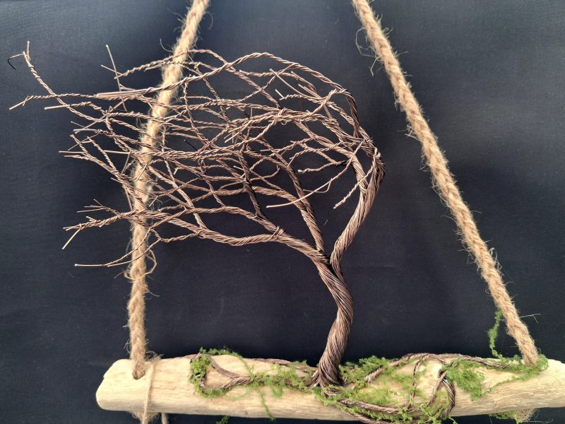 Windswept wire tree on natural driftwood
