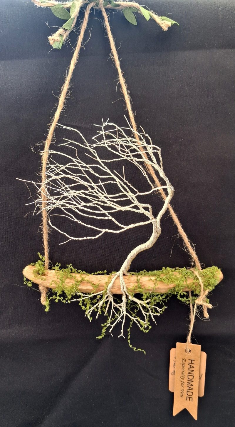 Small silver colour windswept tree on natural driftwood