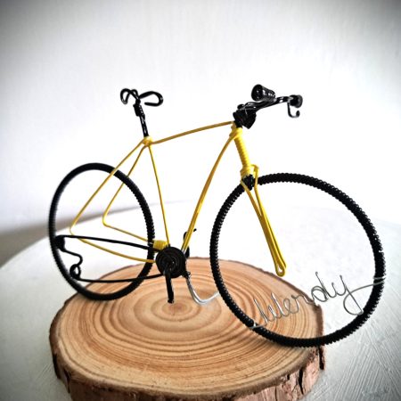 Handmade, yellow colour, road style wire bicycle sculpture. Approximately 9cm long 4.5cm high, personalised with a name written in wire and set into the front wheel.