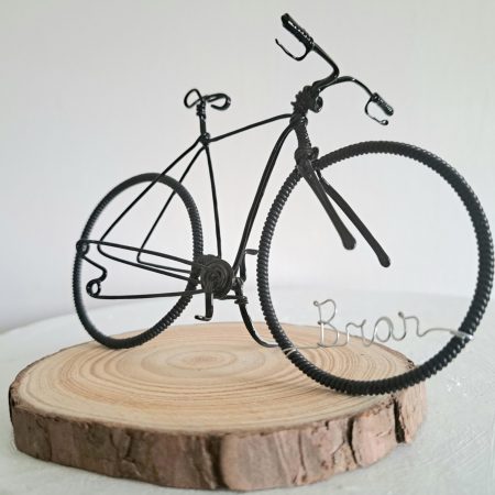 Handmade, black colour, road style wire bicycle sculpture. Approximately 9cm long 4.5cm high, personalised with a name written in wire and set into the front wheel.