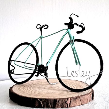 Handmade, mint colour, curved handle bars wire bicycle sculpture. Approximately 9cm long 4.5cm high, personalised with a name written in wire and set into the front wheel.