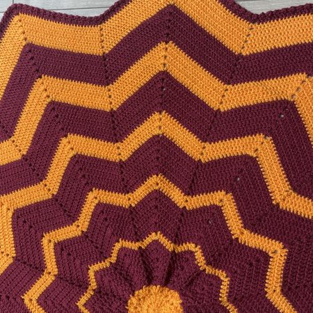 Crochet star shaped blanket in plum and bright orange
