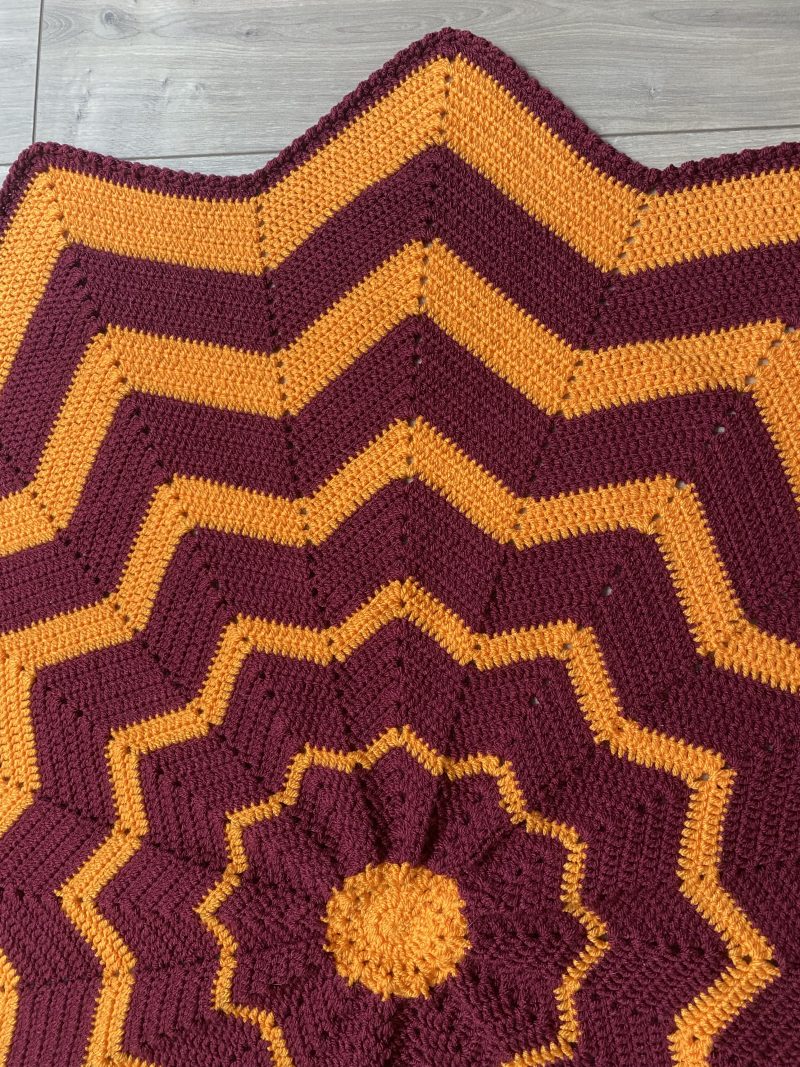 Crochet star shaped blanket in plum and bright orange