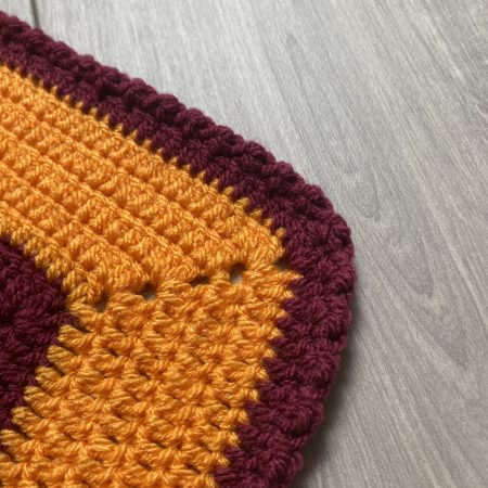 Crochet star shaped blanket in plum and bright orange