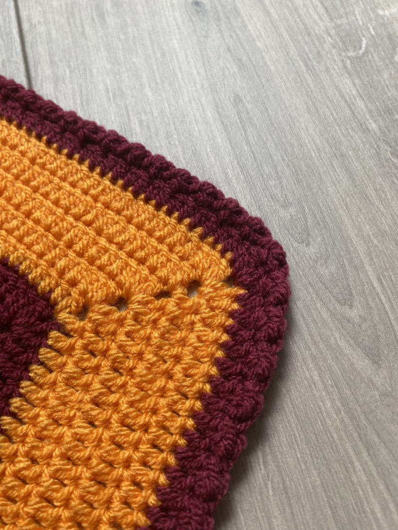 Crochet star shaped blanket in plum and bright orange