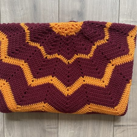 Crochet star shaped blanket in plum and bright orange