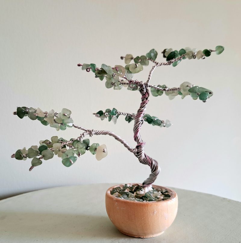 Semi precious green adventurine stone tree sculpture. Stands in a pot decorated with stones.