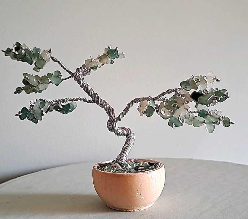 Semi precious green adventurine stone tree sculpture. Stands in a pot decorated with stones.