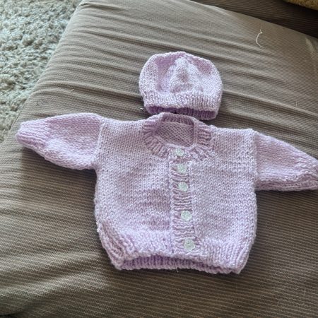 Hand knitted newborn cardigan and hat.