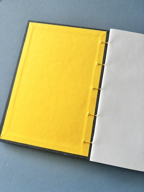 A5 Coptic stitch sketchbook | 48 pages | Blue book cloth cover | Yellow Bookworm | Elastic closure | Hand stitched