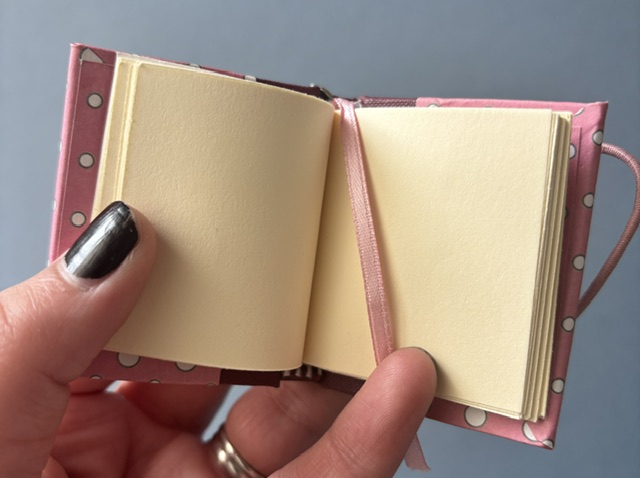 Handmade Notebook Keyring | 48 pages | Burgundy book cloth spine with pink cover with white dots | Unlined paper