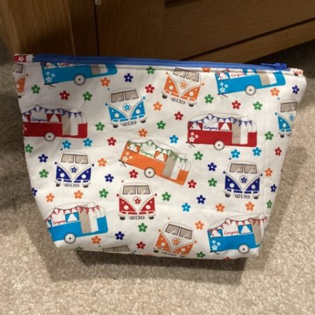 Small/Medium White Multicoloured Campervan Print Fabric Zipped Lined Make Up Bag/Pouch Why not brighten up your holiday essentials with this gorgeous White Multicoloured Campervan Print Fabric Zipped Lined Make Up Bag/Pouch.