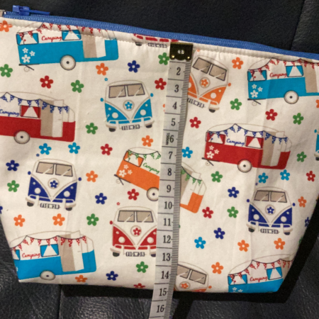 Small/Medium White Multicoloured Campervan Print Fabric Zipped Lined Make Up Bag/Pouch Why not brighten up your holiday essentials with this gorgeous White Multicoloured Campervan Print Fabric Zipped Lined Make Up Bag/Pouch.