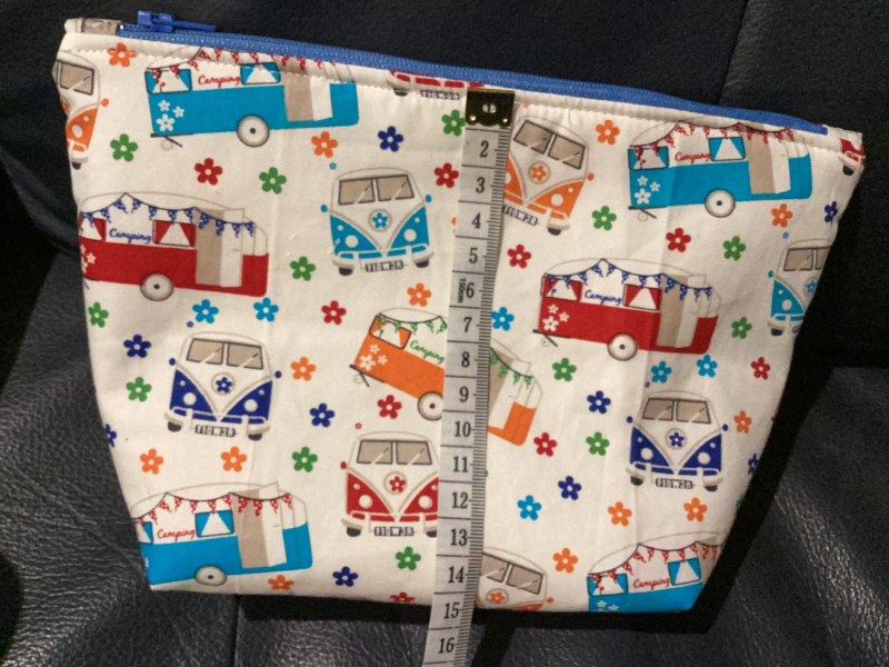Small/Medium White Multicoloured Campervan Print Fabric Zipped Lined Make Up Bag/Pouch Why not brighten up your holiday essentials with this gorgeous White Multicoloured Campervan Print Fabric Zipped Lined Make Up Bag/Pouch.