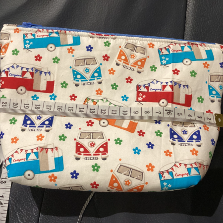 Small/Medium White Multicoloured Campervan Print Fabric Zipped Lined Make Up Bag/Pouch Why not brighten up your holiday essentials with this gorgeous White Multicoloured Campervan Print Fabric Zipped Lined Make Up Bag/Pouch.