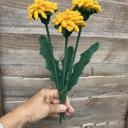 Close-up of handmade crochet dandelions showing the detailed flower heads