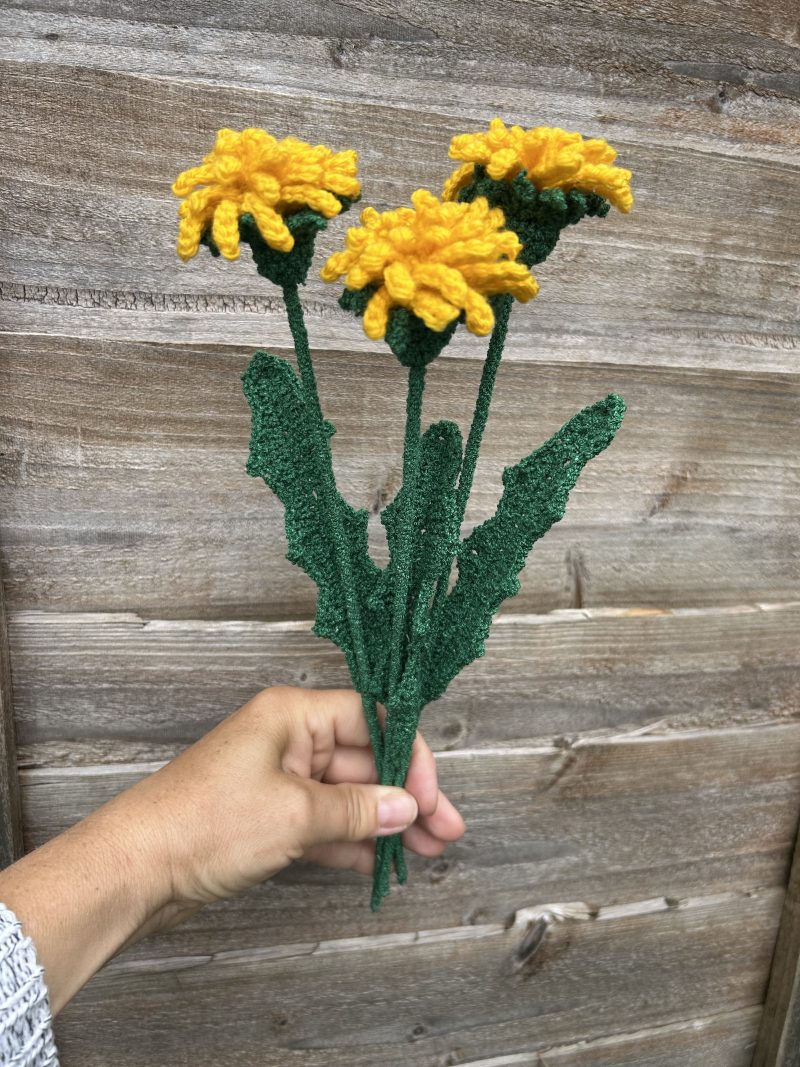 Close-up of handmade crochet dandelions showing the detailed flower heads