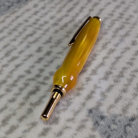 Seam ripper-unpicker made from bright yellow shimmering acrylic