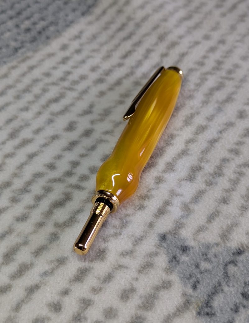 Seam ripper-unpicker made from bright yellow shimmering acrylic