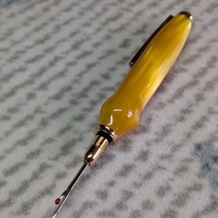 Seam ripper-unpicker made from bright yellow shimmering acrylic