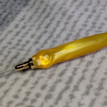 Seam ripper-unpicker made from bright yellow shimmering acrylic