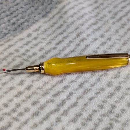 Seam ripper-unpicker made from bright yellow shimmering acrylic