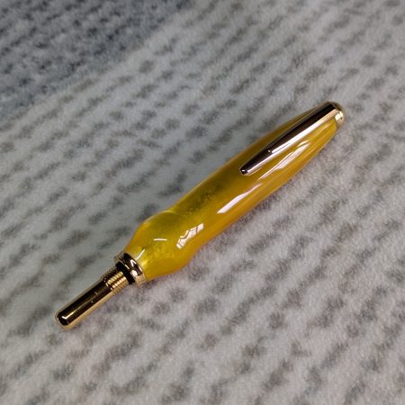 Seam ripper-unpicker made from bright yellow shimmering acrylic