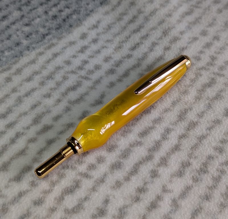 Seam ripper-unpicker made from bright yellow shimmering acrylic