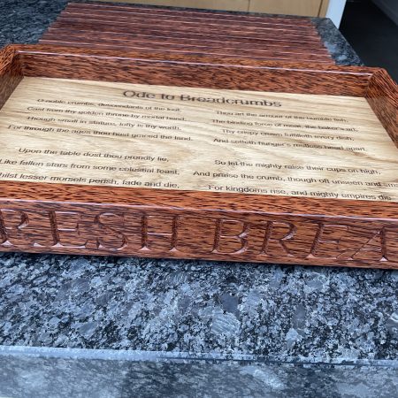 A premier coconut and oak crumb catcher bread board