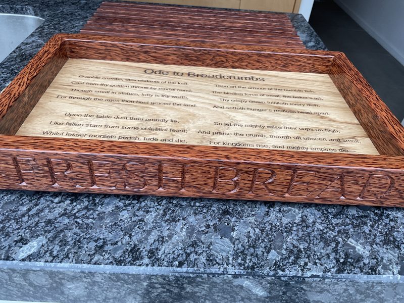 A premier coconut and oak crumb catcher bread board