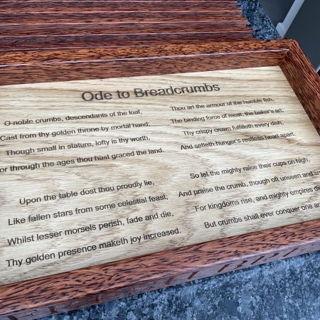 A premier coconut and oak crumb catcher bread board