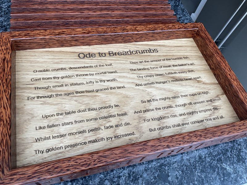 A premier coconut and oak crumb catcher bread board