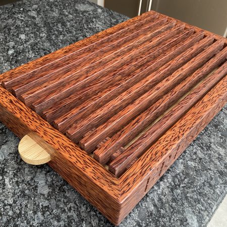 A premier coconut and oak crumb catcher bread board