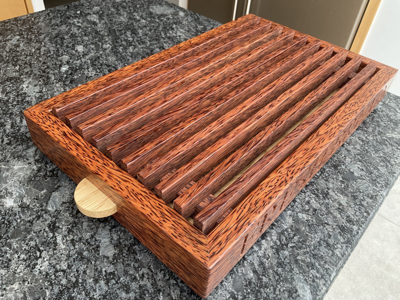 A premier coconut and oak crumb catcher bread board