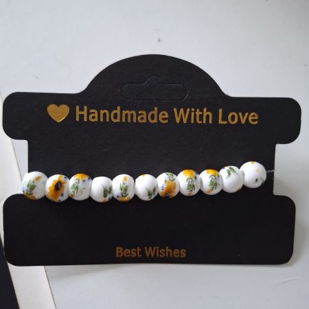 White ceramic beaded bracelet with sunflower print