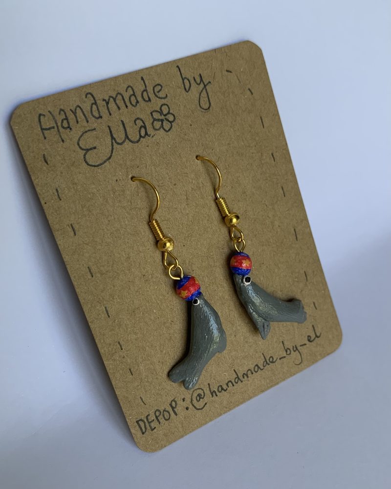 Hand-sculpted and painted sea lion earrings with gold tone stainless steel hooks