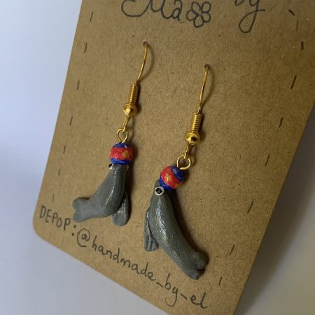 Hand-sculpted and painted sea lion earrings with gold tone stainless steel hooks