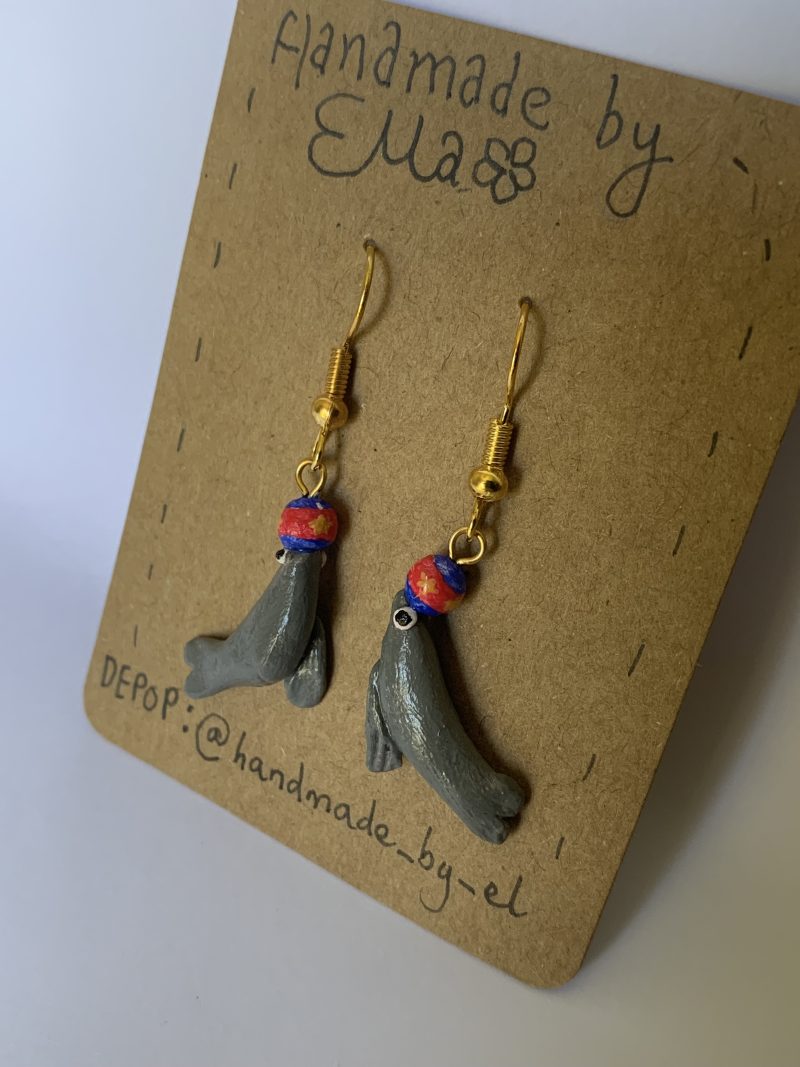 Hand-sculpted and painted sea lion earrings with gold tone stainless steel hooks