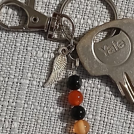 Beaded keyring with wings and with natural crystals.