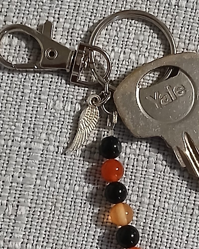 Beaded keyring with wings and with natural crystals.