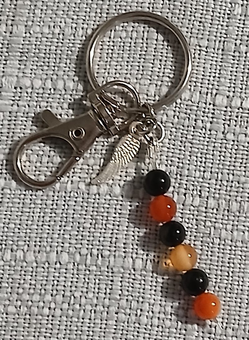 Beaded keyring with wings and with natural crystals.