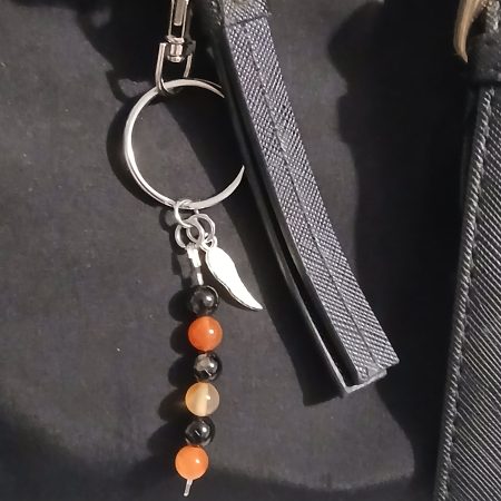 Beaded keyring with wings and with natural crystals.