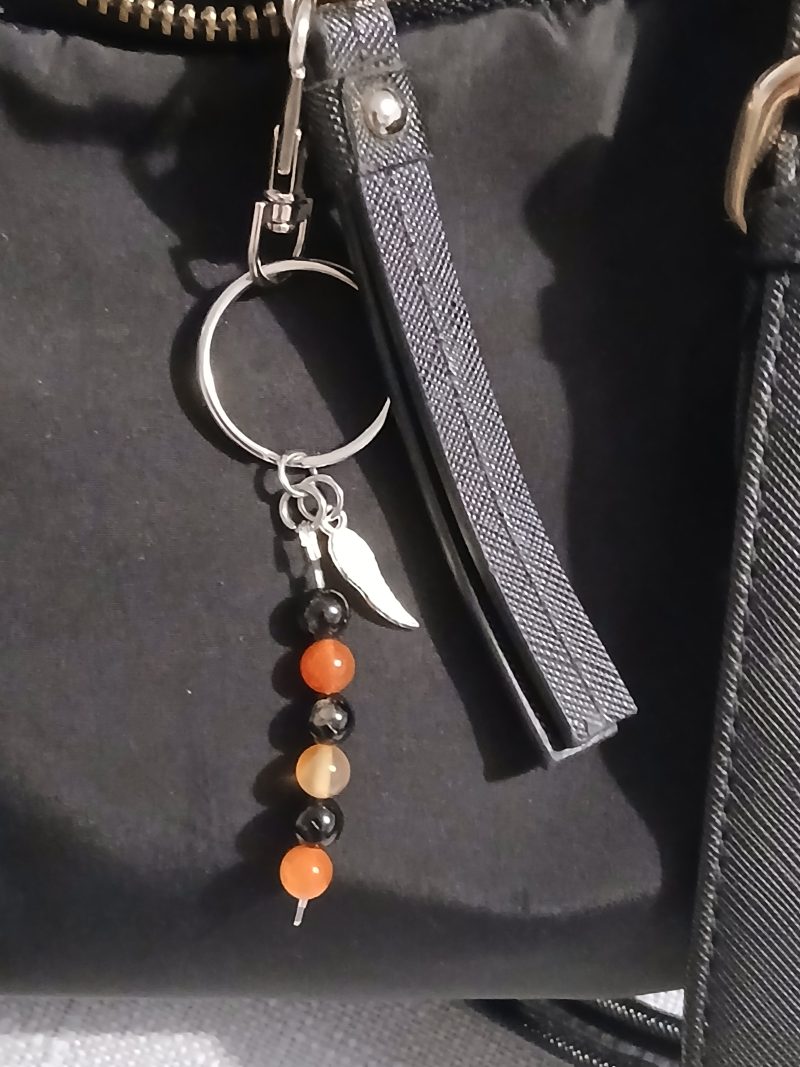 Beaded keyring with wings and with natural crystals.