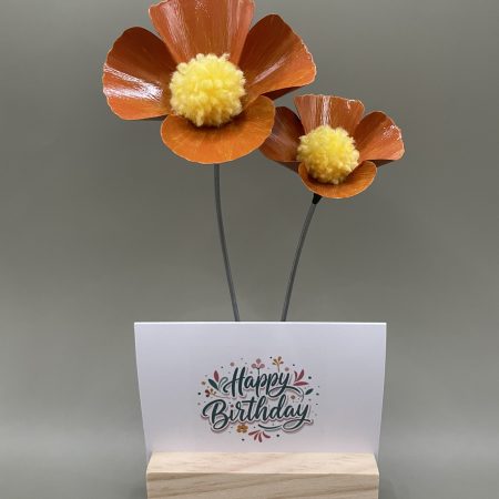Hand crafted orange and yellow metal flowers with birthday card and stand