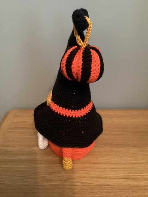 Hand made crocheted Halloween Gnome, main colours orange ,black, white and gold. 30cm tall.