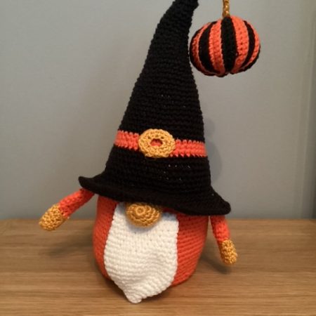 Hand made crocheted Halloween Gnome, main colours orange ,black, white and gold. 30cm tall.