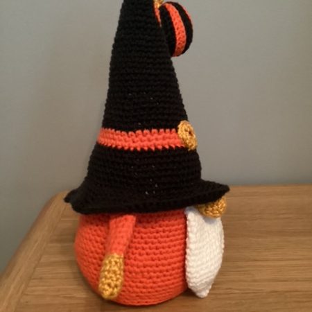 Hand made crocheted Halloween Gnome, main colours orange ,black, white and gold. 30cm tall.