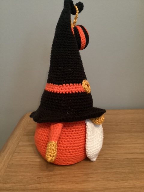 Hand made crocheted Halloween Gnome, main colours orange ,black, white and gold. 30cm tall.